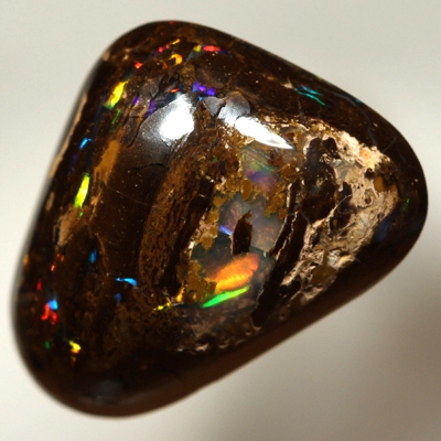 SOLID BOULDER OPAL High dome with very bright rolling flashes of red, orange, yellow, green, blue.
